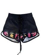 Black shorts with colorful designs on a white background